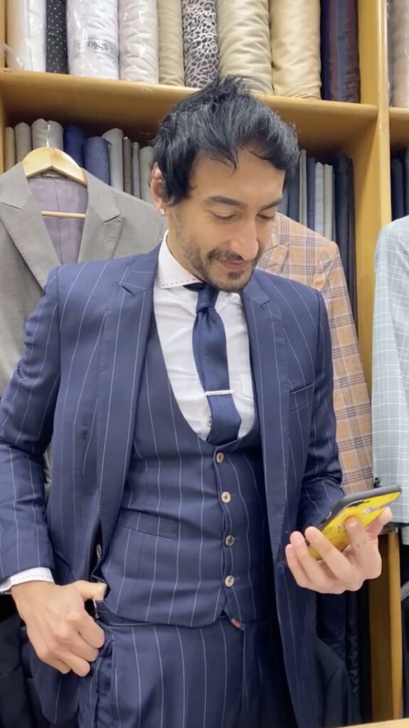 Roshan Checks his phone in store