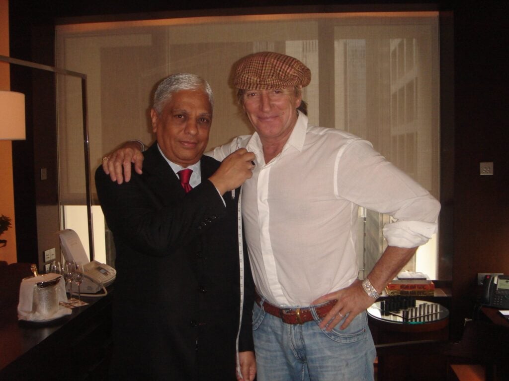 Rod Stewart measures up for bespoke fashion in his hotel room with Manu Melwani