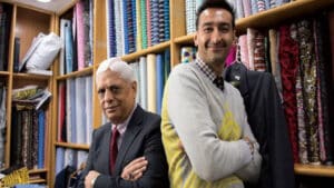 Roshan Melwani nd Manu Melwani two generations of bespoke tailoring in front of their huge range of specialist fabrics